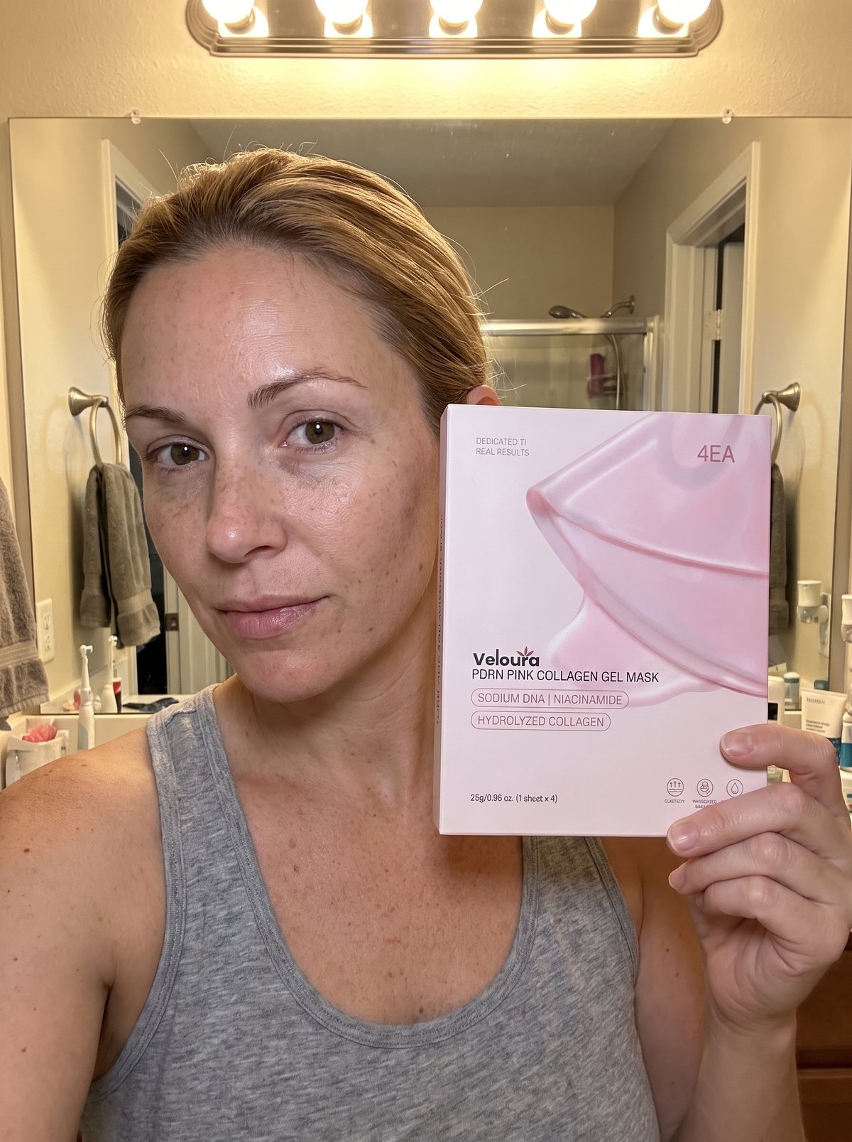 Holding a box of the masks at the bathroom mirror.